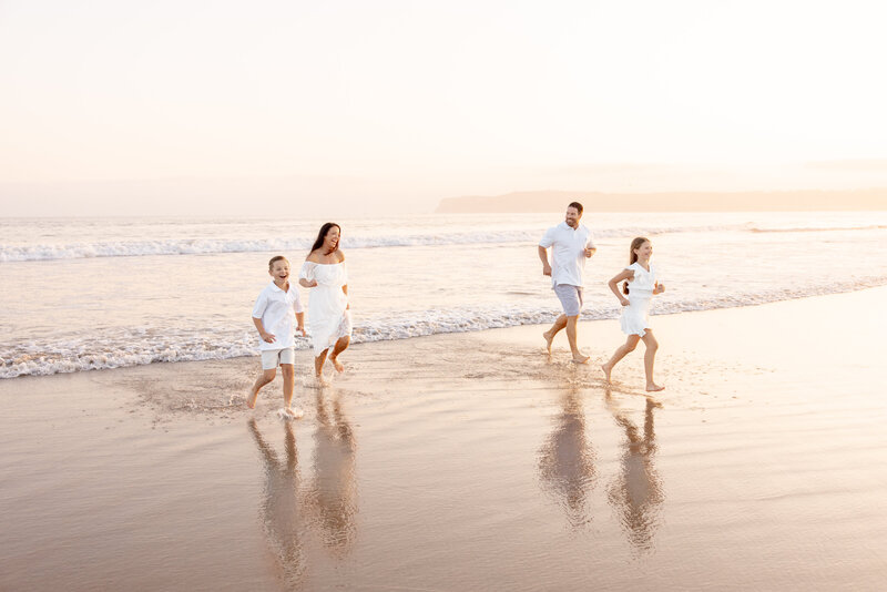 beautiful family walking at the beach in san diego enjoying their photography by Mattie Taylor Photography