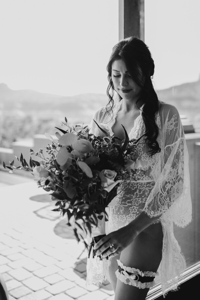 bride holds her bouquet in bridal boudoir before her wedding