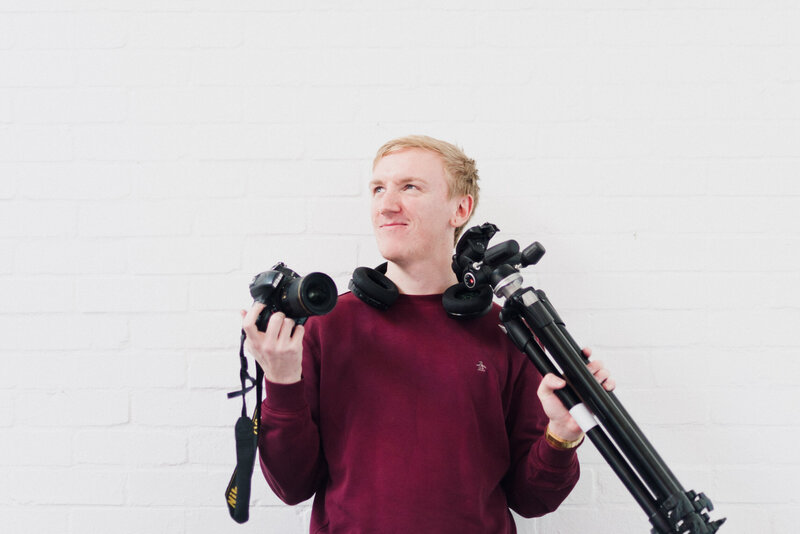 Aaron of Plymouth Marketing Agency Established By Her holding a camera and a tripod
