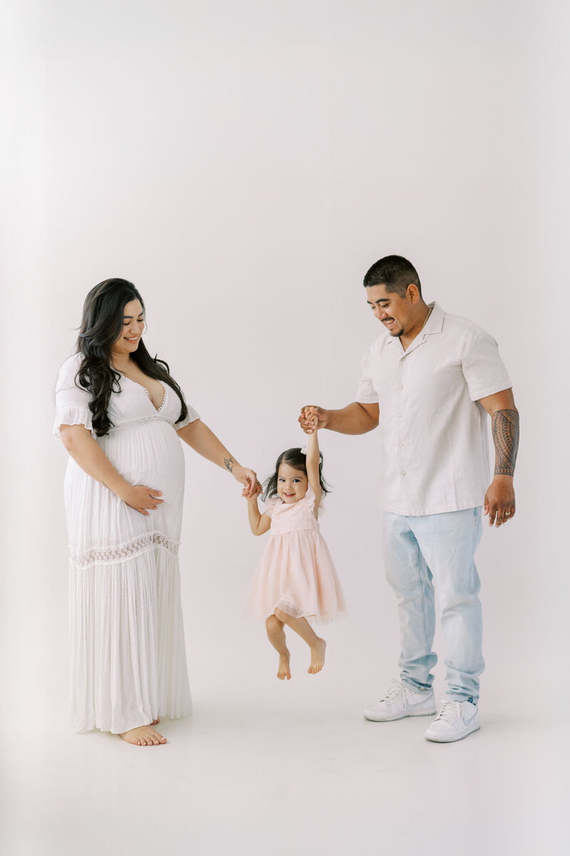 Mother-to-be in soft neutral gown during light and airy Fresno maternity photography session