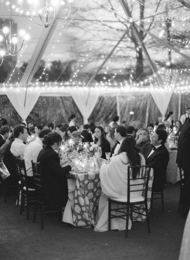 Black and white film image of a tented wedding at Merrimon Wynne by Megan Travis Photography.