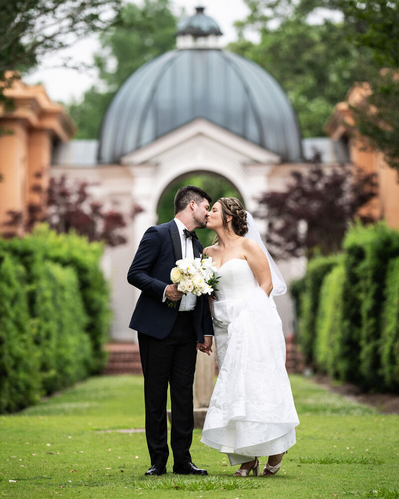 Bride and groom kiss in City Park Botanical Garden wedding in New Orleans