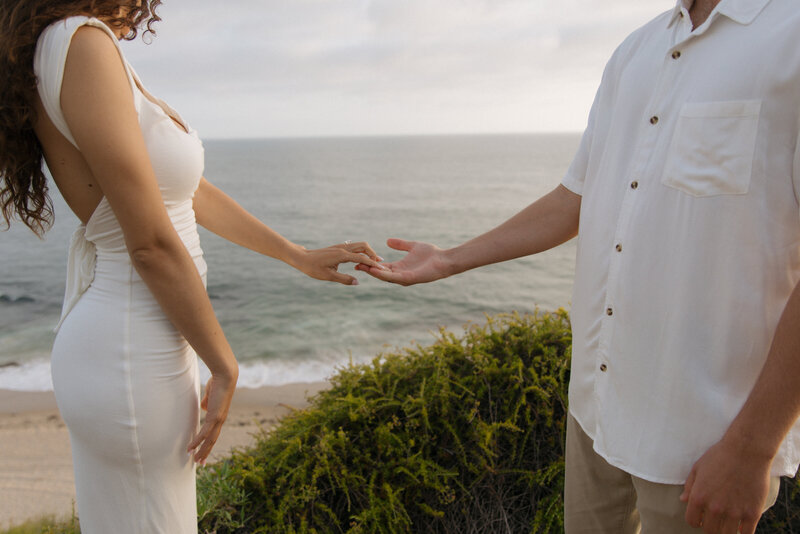 couple holding hands on beach