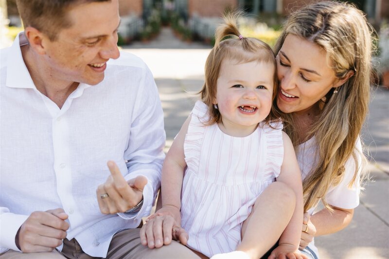 family session at filoli in bay area, toddler smiling at camera with mom and dad