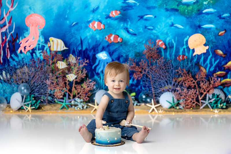 Baby boy smiles in an ocean themed cake smash photoshoot in Myrtle Beach