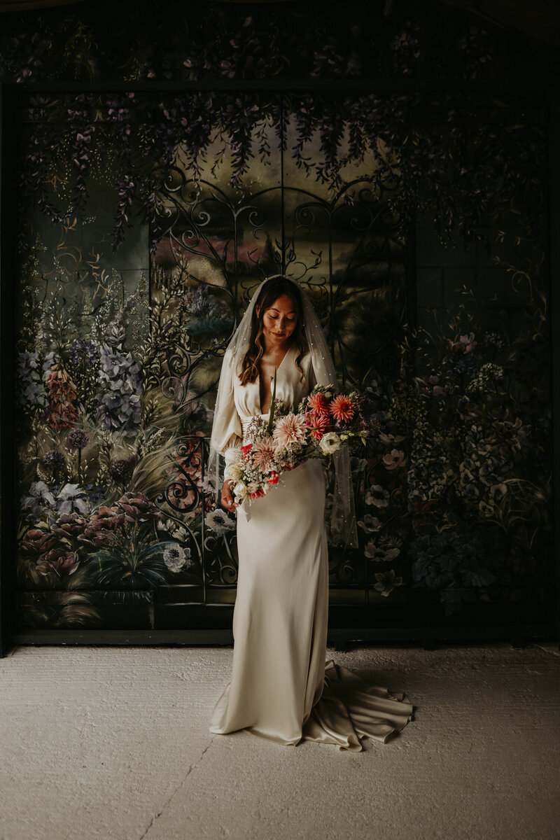 Bridal portrait in front of the mural inside the prep suite at Rhyse Farm. 