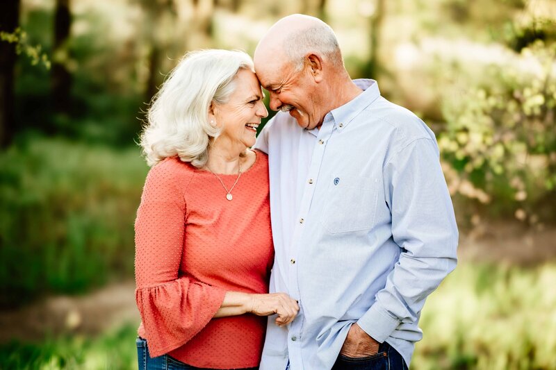 grandma and grandpa share a hug and smiles during family photo session