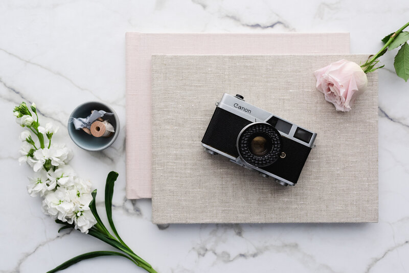 flat-lay of wedding album and camera for JEMMAN Photography