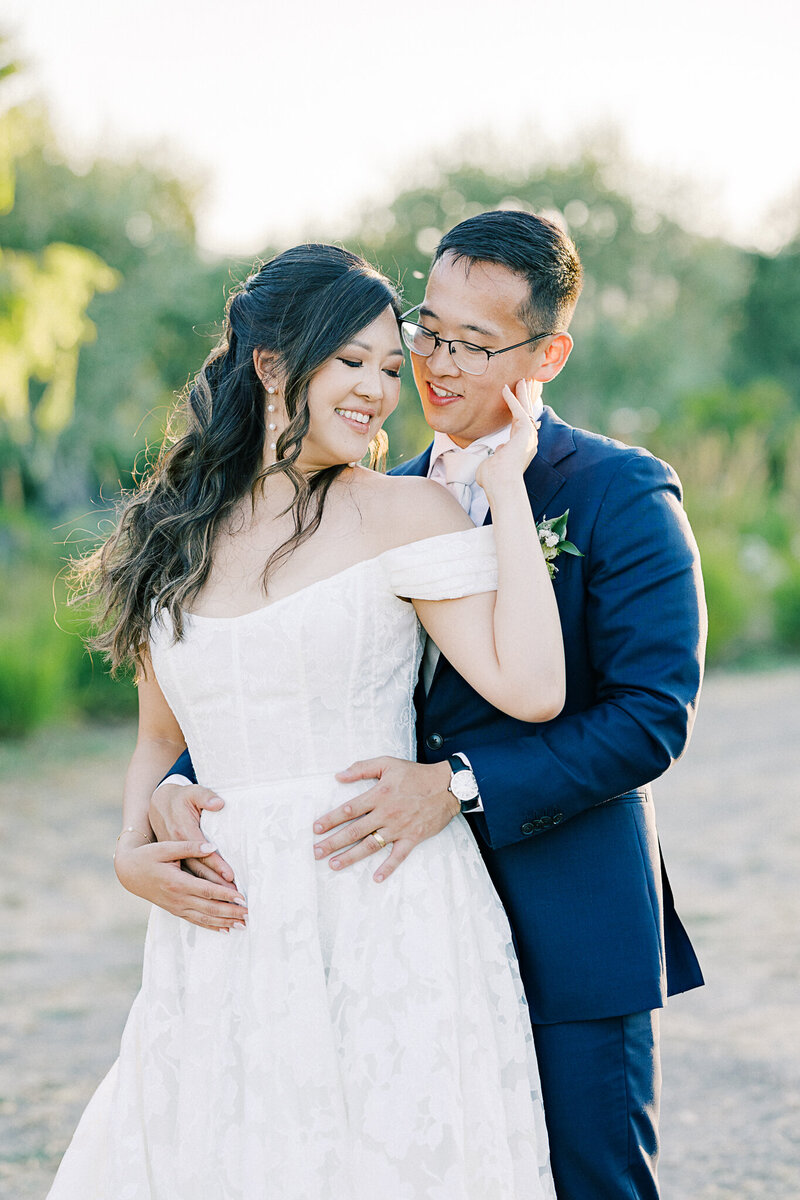 Elegant wedding couple sharing a romantic moment at Harrow Cellars, Bay Area, surrounded by vineyard views and fine art wedding details.