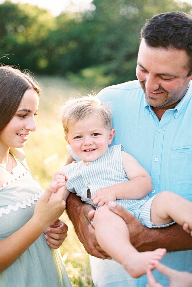 A candid family portrait taken by Emily Barbara Milwaukee family photographer, featuring a dad with his daughter and son.