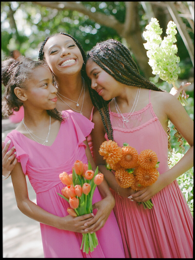 little girl bridesmaids hugging