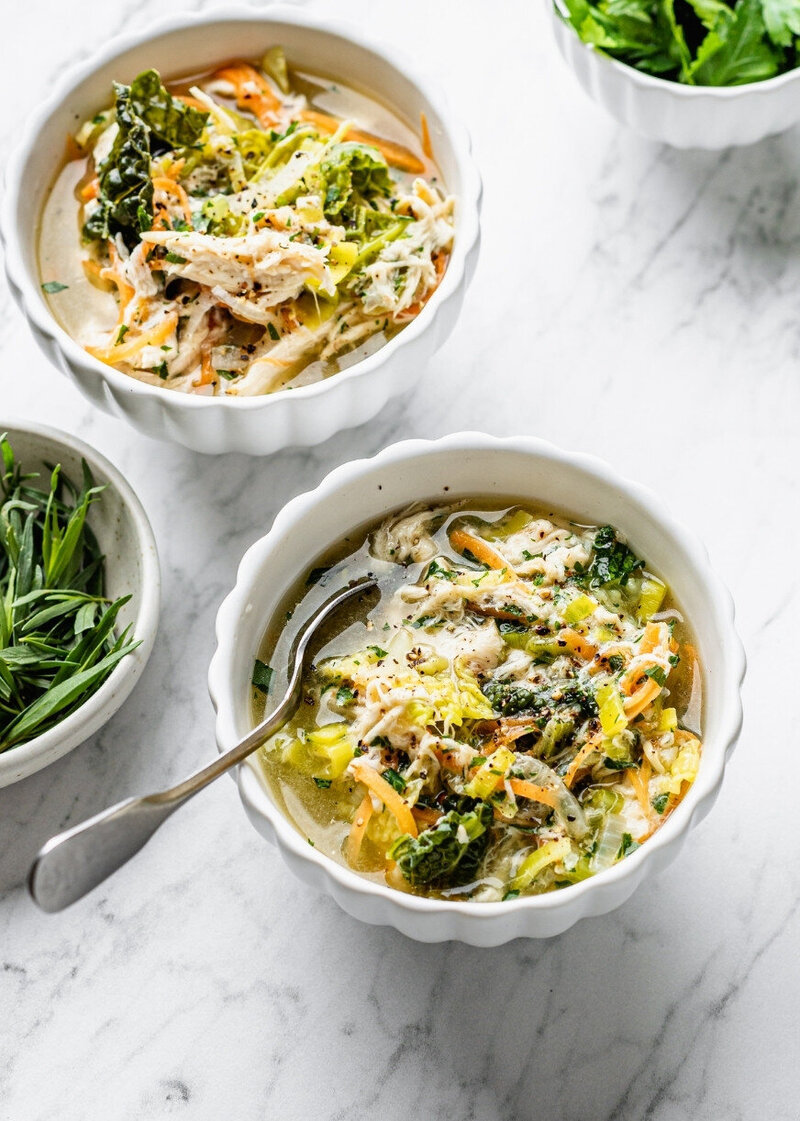 Chicken Broth Menopause Abundance Bowl™ served in a white bowl, packed with shredded chicken, leafy greens, and colourful vegetables, part of the Menopause.Rescripted Recipe Vault.