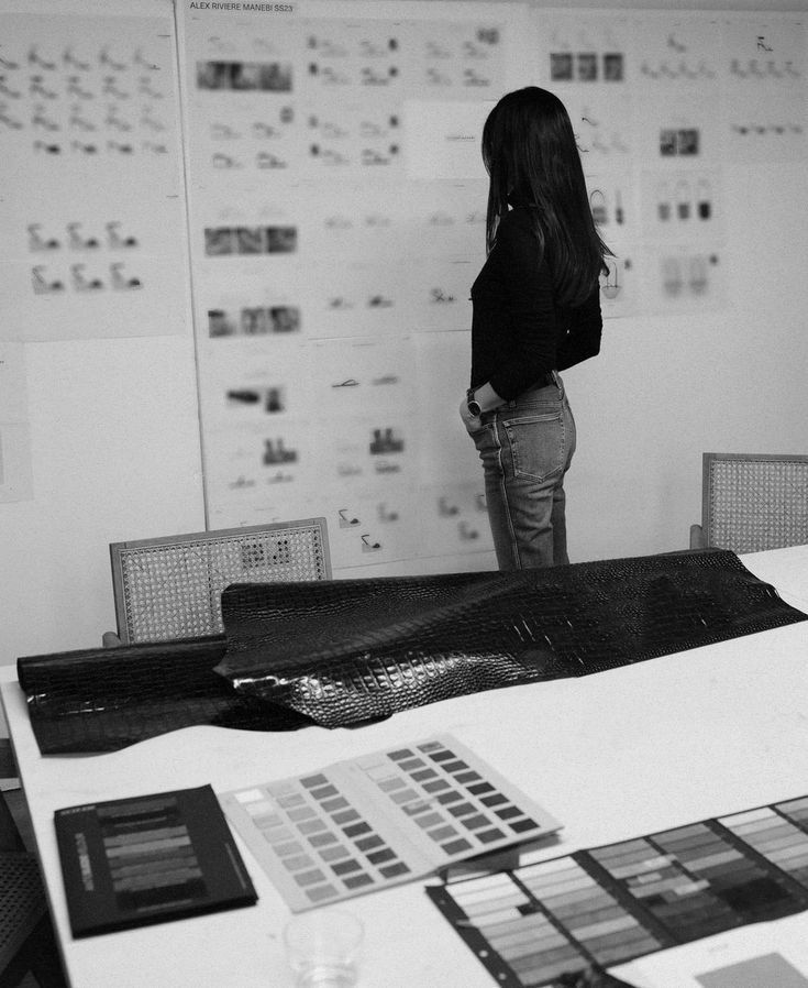 Ayah Official reviewing strategy boards, representing her process of helping women design intentional, scalable businesses through mentorship and clarity.