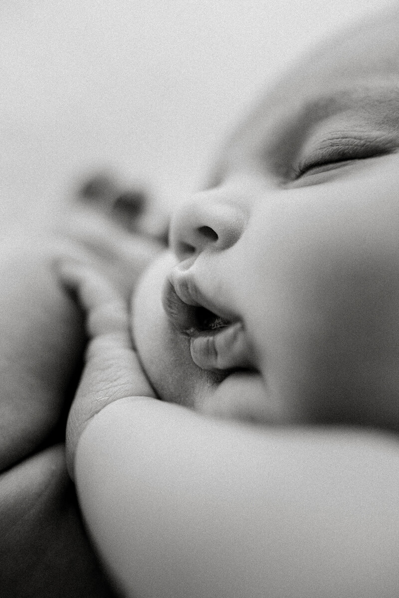 A macro photograph in black and white of a newborn babies facials taken during a newborn photograph shoot with christchurch newborn photographer lucy jane photography