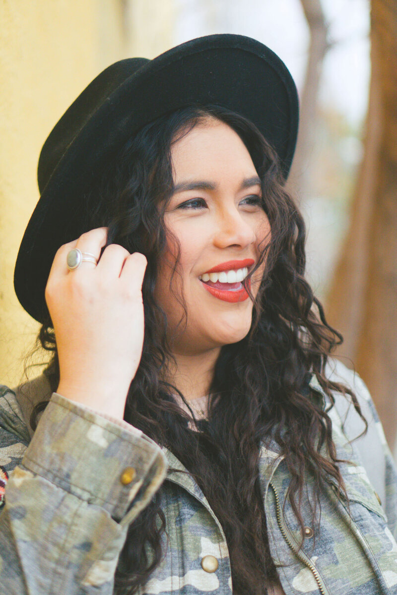 Woman wearing a black hat happily looking at the view
