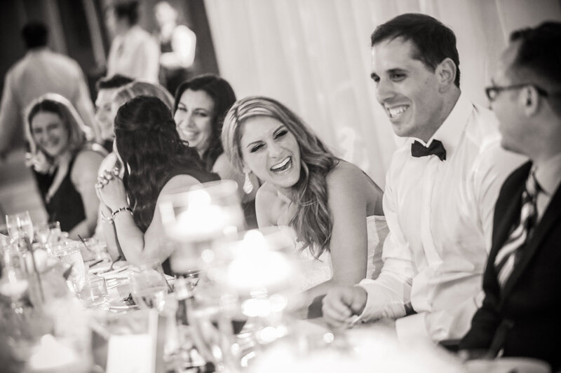 bride-laughing-at-head-table