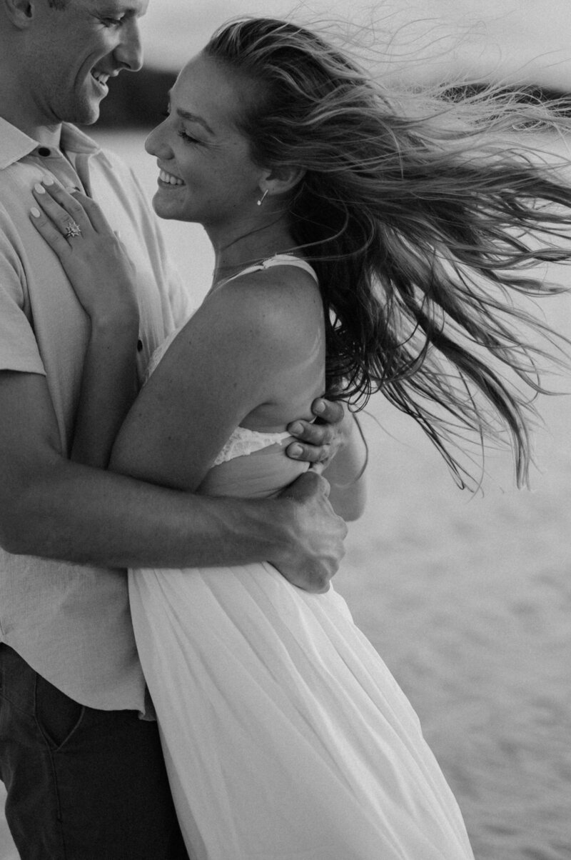 man and woman smiling and embracing