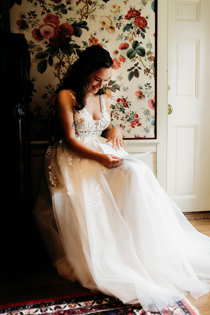 Bride reads a letter from her fiance before their wedding