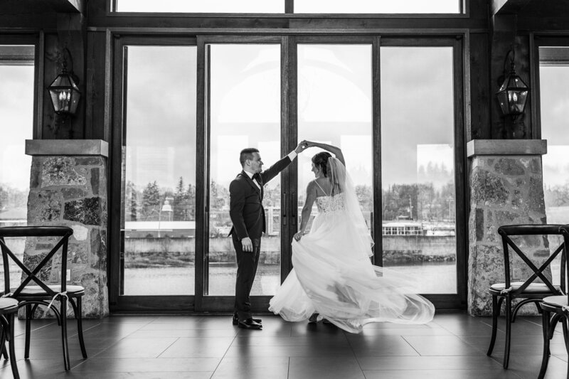 Black and white photo of newlywed couple dancing