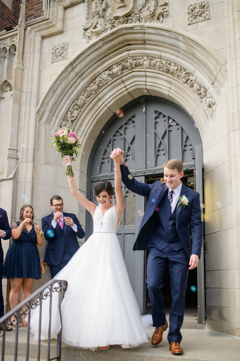Bride and Groom exiting their chapel to guests throwing confetti