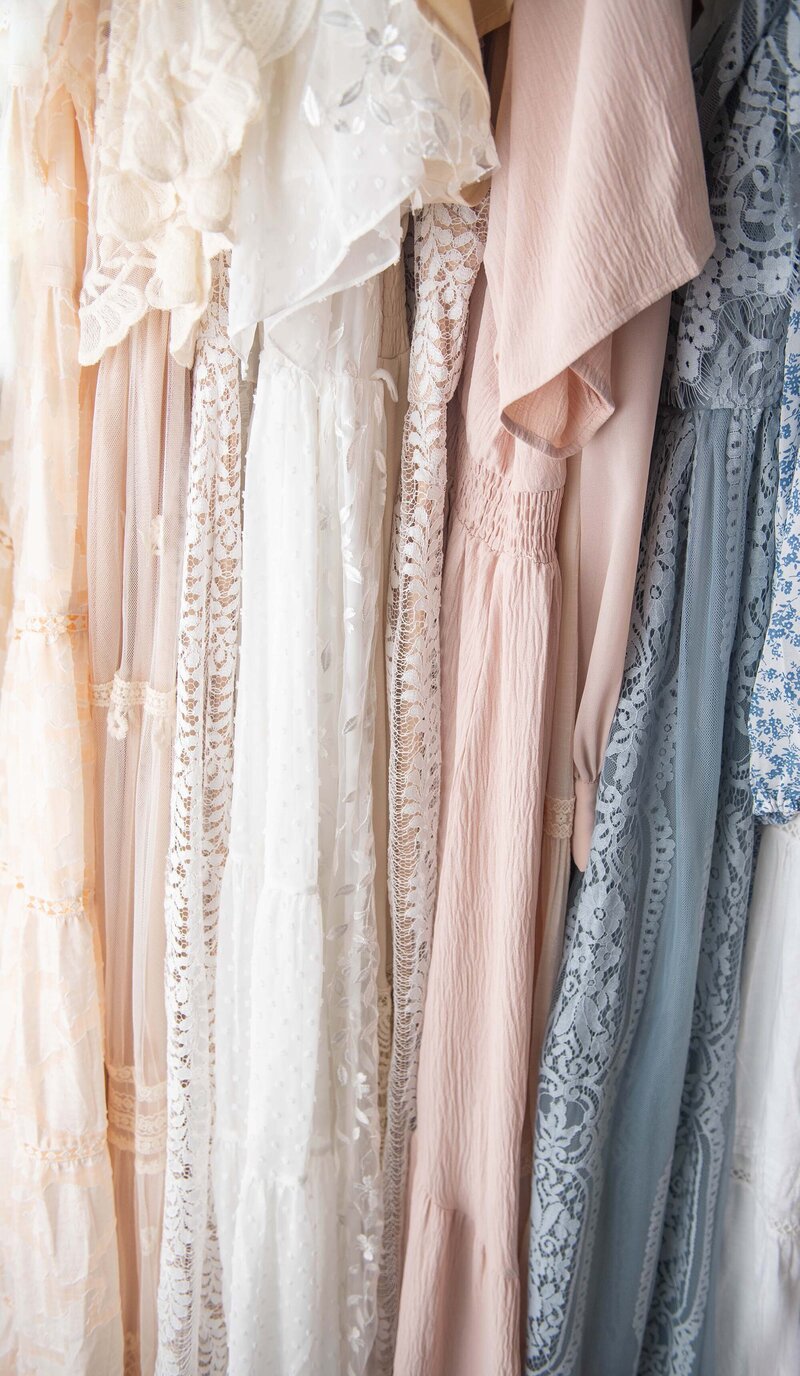 Dresses hanging on a rail at a luxury maternity photoshoot.