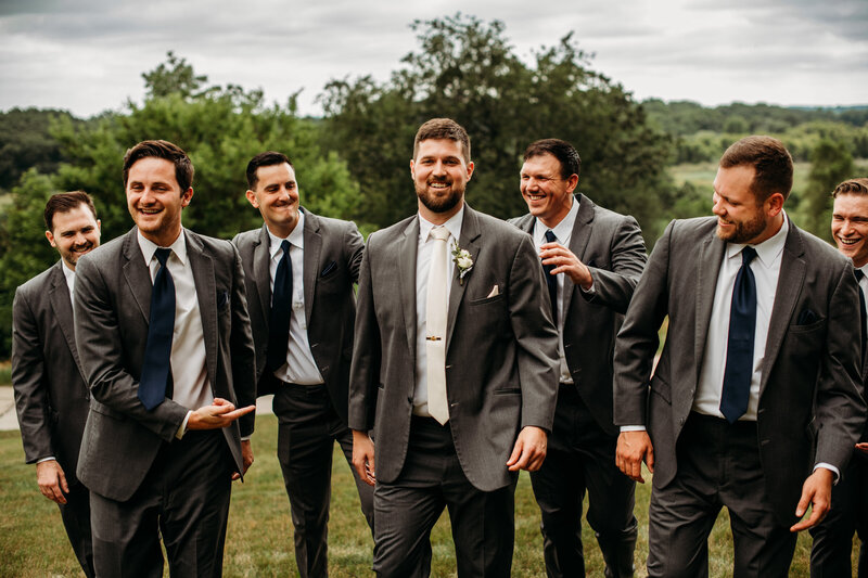 Groom and groomsmen walking and smiling at each other