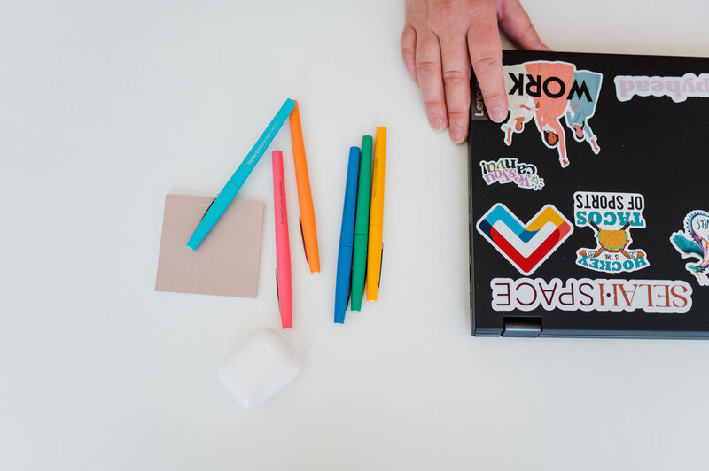 Copywriting supplies on a desk, like pens and sticky notes