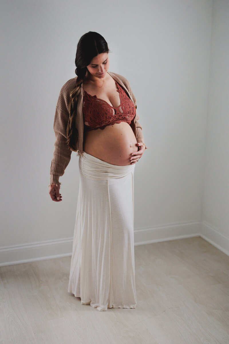 Pregnant woman looking down at belly in Ocean View, New Jersey