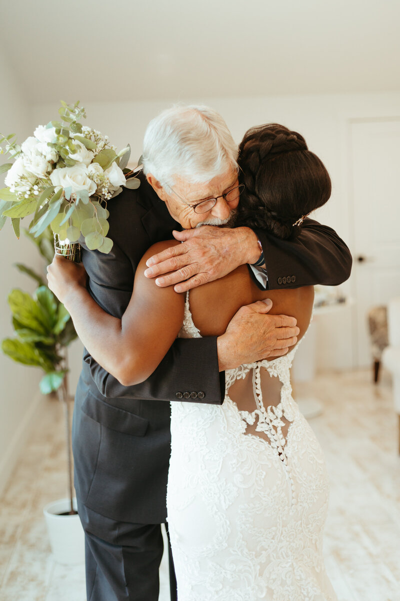 Bride hugs her grandpa at the Barn at Grace Hill after their first look with eachother - Ashley Cole Photography