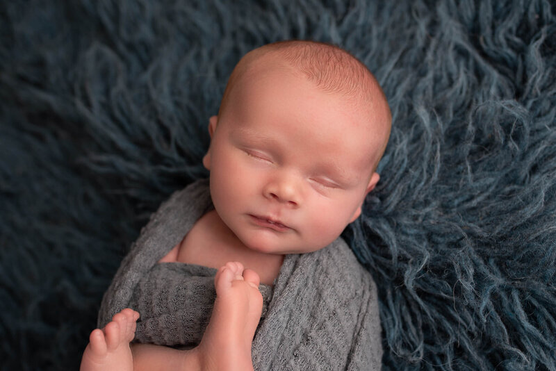 Fond du Lac Newborn Photo baby sleeping on blue rug in studio | Glory Be Photo by Tara Bos