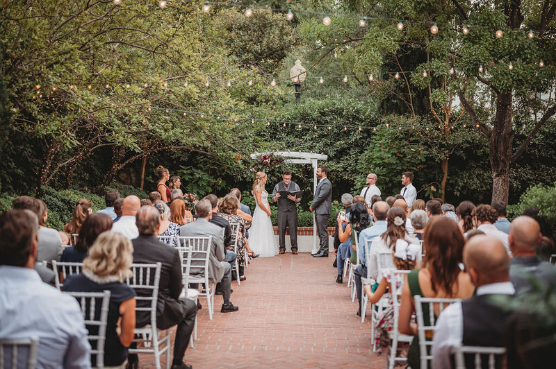 A beautiful ceremony held in the Gardens Courtyard under a beautiful tent.