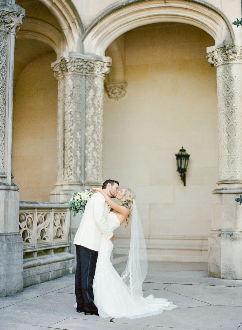 Bride and Groom Kissing in Front of Biltmore Estate Photo