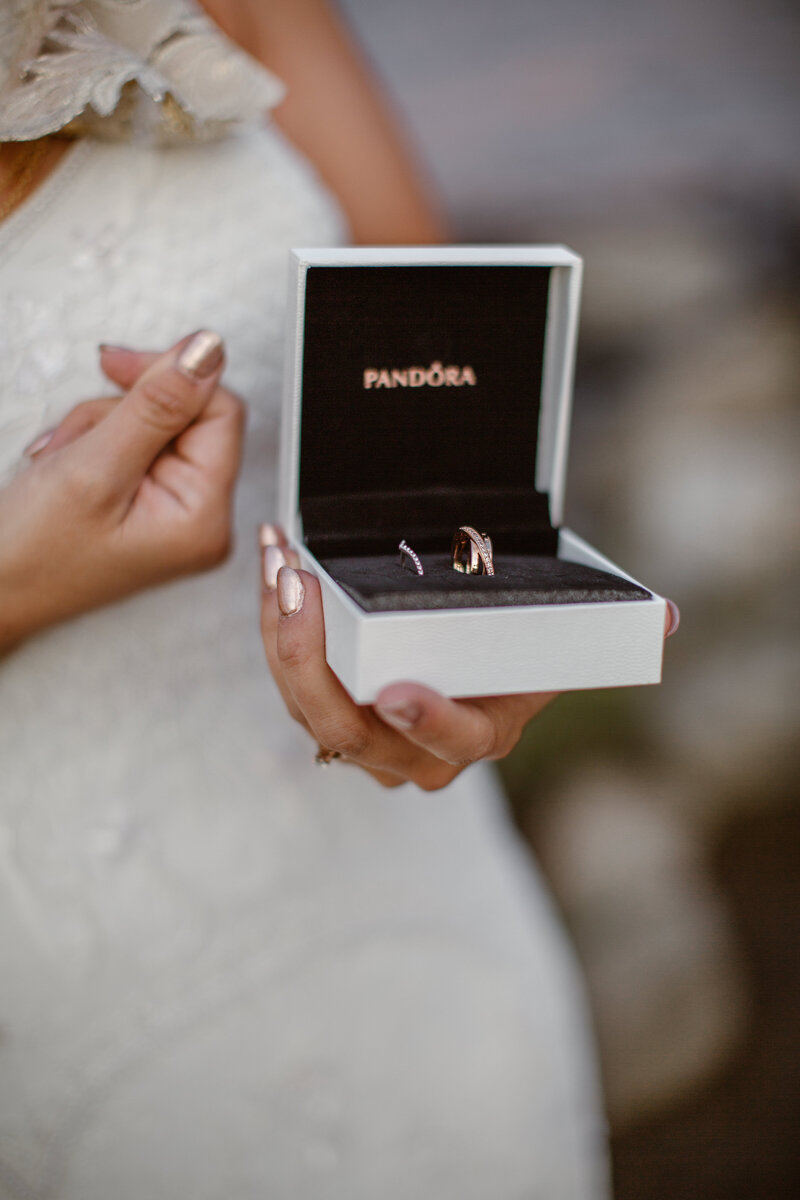 bride holding wedding rings
