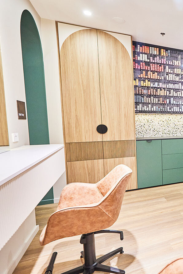 Contemporary salon interior with a focus on men's haircut services, showcasing stylish seating and wooden accents.