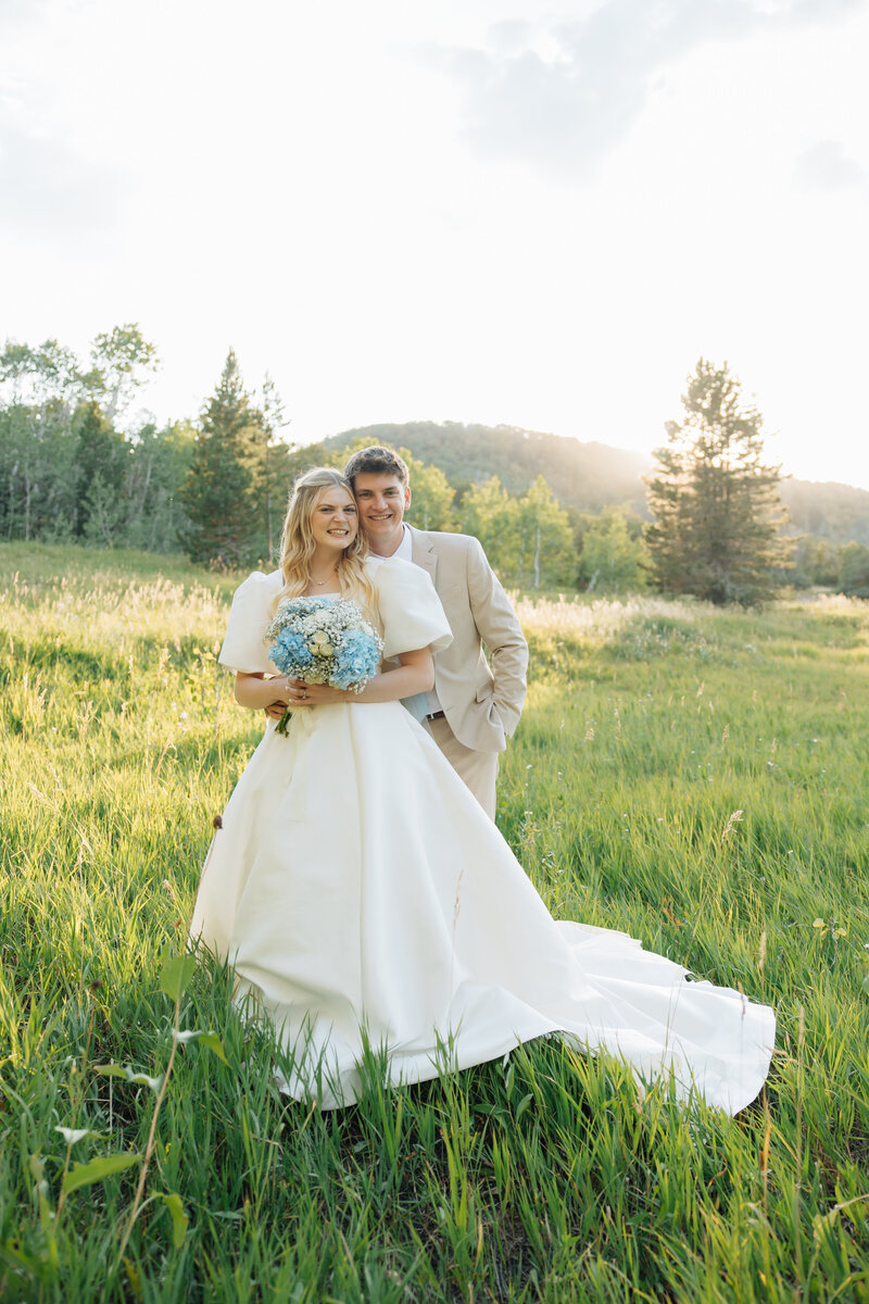 mother and baby smile in orchard in santaquin, utah