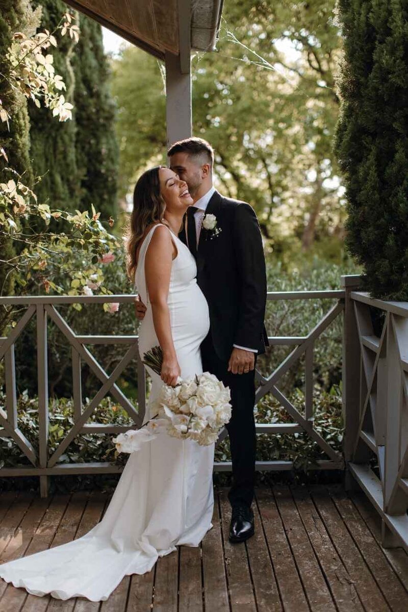 Bride and groom hugging each other.