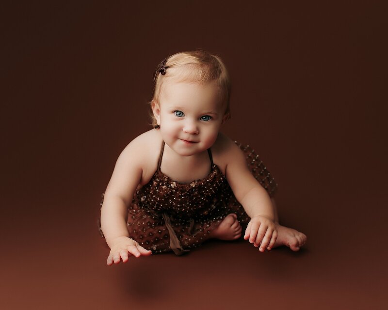 Minimal milestone session with baby on neutral cream backdrop
