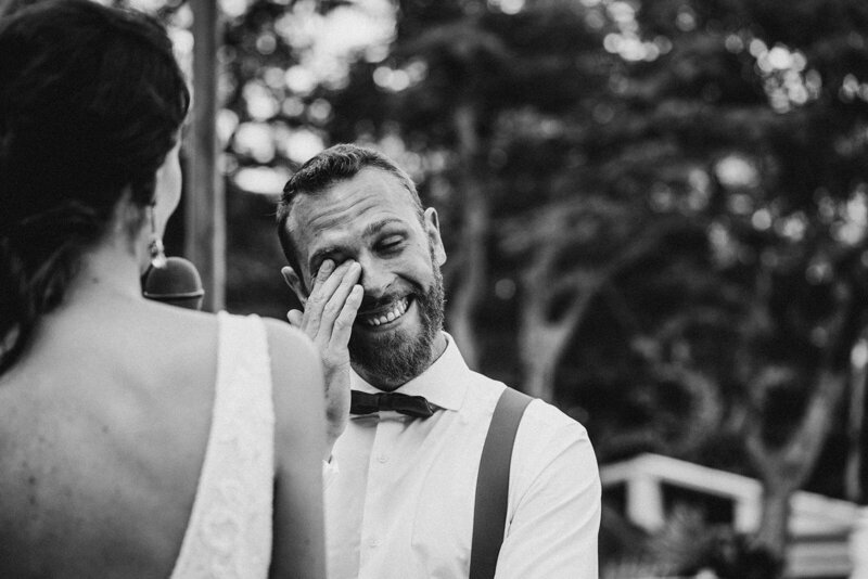 emotional groom wiping tears during vow exchanges