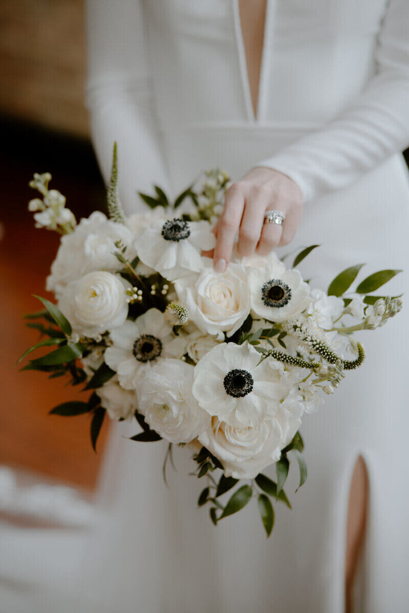 Bride holding wedding flowers in bouquet designed by wedding florists minneapolis