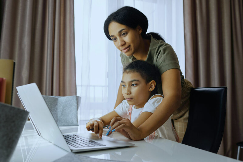 woman and her kid looking at a computer