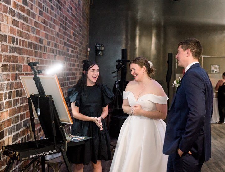 bride and groom admiring a painting