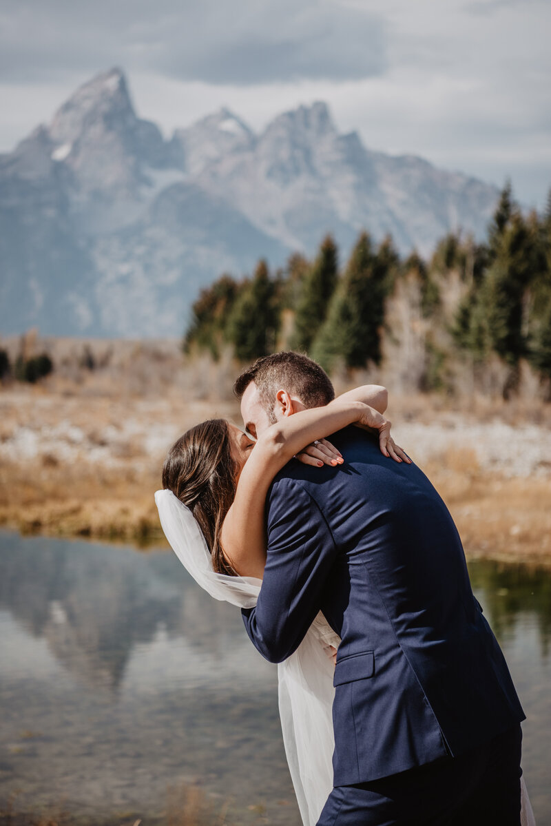 first kiss as husband and wife for their jackson hole wedding