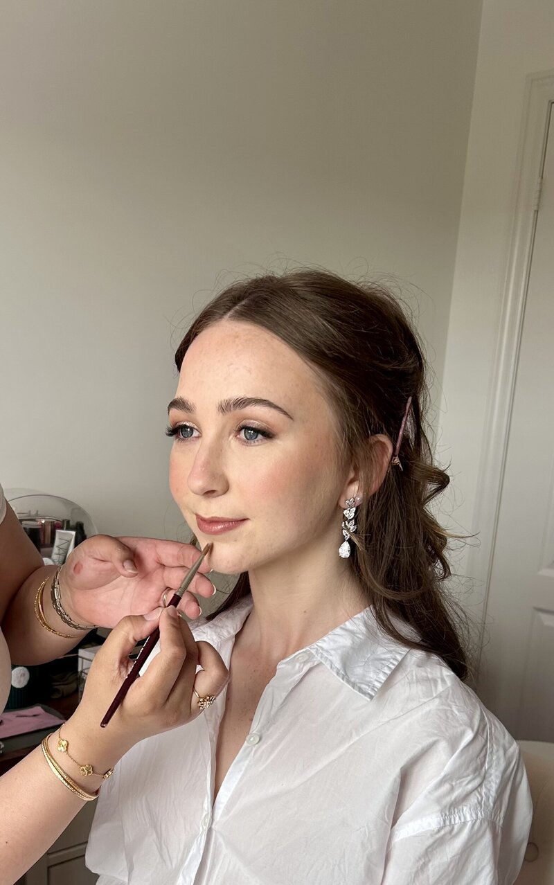 Confident client posing post-makeup session