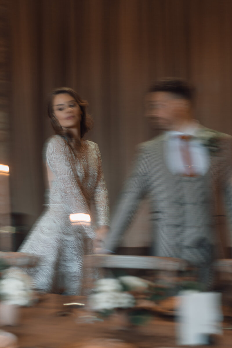 Wedding photographer captures couple taking a stroll hand in hand at their french chateau wedding.