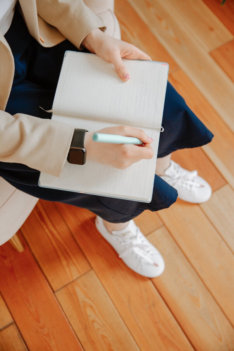 Woman handwriting in notebook