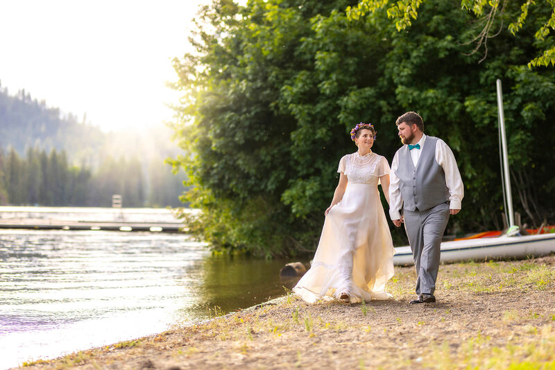 CDA wedding photographer takes pictures on the shore for a woodland wedding