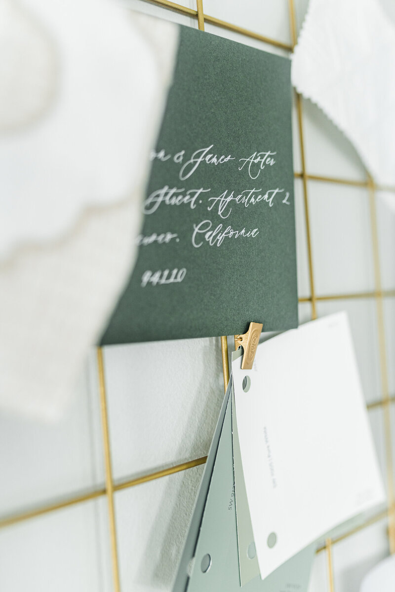 close up of calligraphy on green wedding invitation