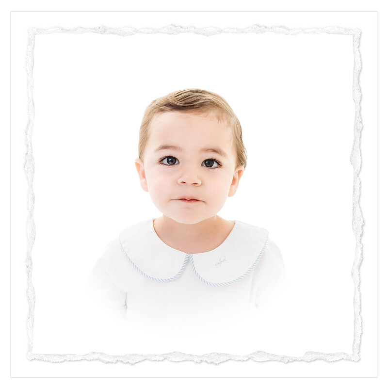 A heirloom headshot of a 1 year old baby boy on an all white backdrop. The picture was shot in a clean, classic and timeless style by Baytown photographer Bri Sullivan.