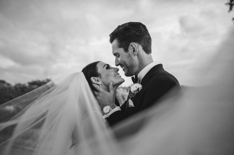 Bride and groom kiss  black and white