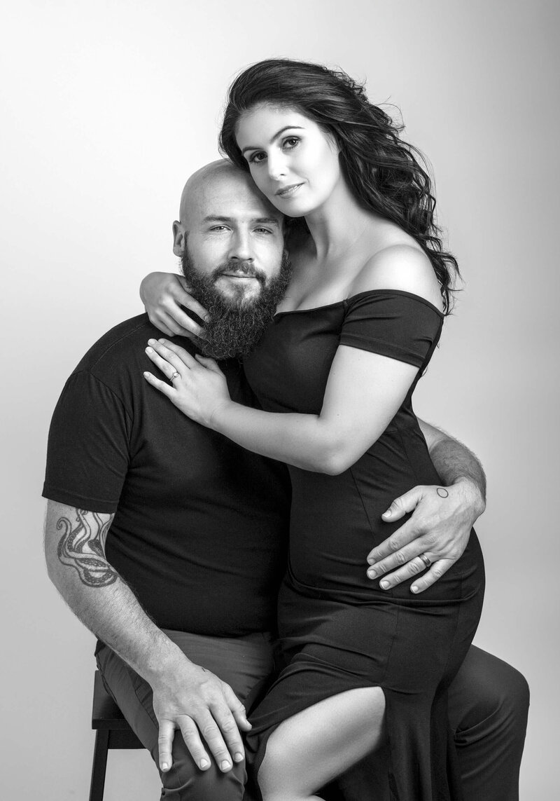 classic black-and-white portrait of a couple woman sitting on his lap